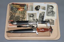 A collection of World War II ephemera including seven black and white photographs,