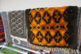 Four assorted fringed rugs