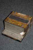 An accordion with mother of pearl buttons