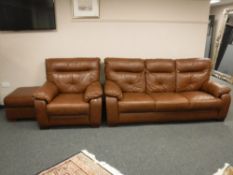 A brown leather three seater settee, matching armchair and stool.