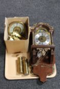 A Franz Hermle wall clock with pendulum and weights together with a box containing clock parts
