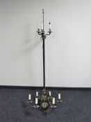 A continental brass and metal three way standard lamp on paw feet together with a six-way light