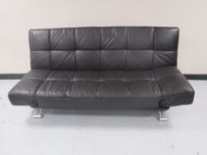 A contemporary brown leather folding bed settee