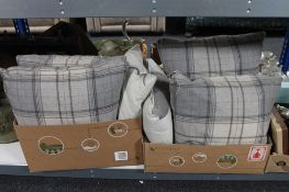Two boxes containing four large tartan cushions together with two stag print cushions