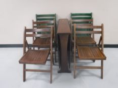 A mahogany drop leaf dining table together with six folding chairs