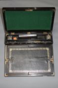 A Victorian fitted writing slope with inkwells
