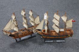Two wooden galleons on stands