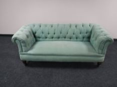 A Victorian Chesterfield settee upholstered in a green button fabric