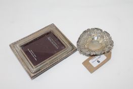 A sterling silver heart shaped dish together with a silver photo frame