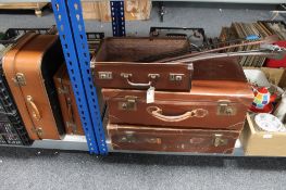 Five vintage leather luggage cases together with four riding crops