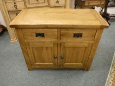A contemporary oak double door sideboard fitted with two drawers