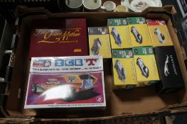 A box containing Atlas Edition die cast vehicles,