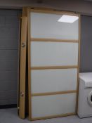 A contemporary beech sliding glass door wardrobe with down lights (dismantled)