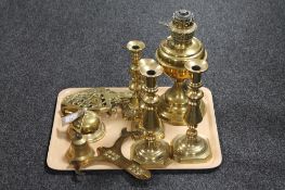 A tray of brass ware including candlesticks, desk bell, trivets,