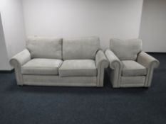 A two-seater bed settee and armchair upholstered in a beige fabric