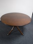 A Regency style circular inlaid mahogany pedestal dining table