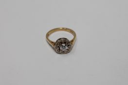 An 18ct gold diamond cluster ring, the central stone estimated at 0.