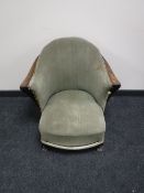An early 20th century oak framed Art Deco armchair
