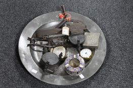 An antique pewter charger containing animal trap, vintage secateurs, metal boxes,