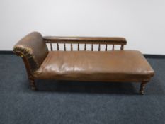 A Victorian mahogany chaise longue upholstered in a brown leather
