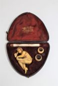 A 19th century carved erotic Meerschaum and ivory pipe, in original case.