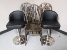 Three oak wheel back chairs together with a pair of contemporary gas lift breakfast bar stools