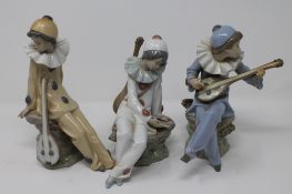 Three Nao figures - Seated clowns with mandolins CONDITION REPORT: Yellow clown's