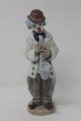 A Lladro figure - Clown playing the trumpet CONDITION REPORT: In good condition with