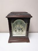 An early 20th century German bracket clock with pendulum and key.