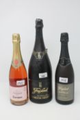 A Freixenet 150 cl bottle of Cava, together with two smaller bottles of Cava.