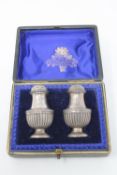 A pair of silver pepperettes in case CONDITION REPORT: Height 6cm. 44g gross.
