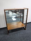 A mid twentieth century teak sliding glass door bookcase