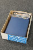 A box of two albums of stamps,