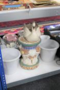 A china elephant plant stand together with a swan planter and two further pots