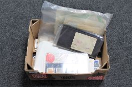 A box of assorted loose British stamps and presentation sets together with a bag of early twentieth