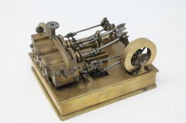 A scratch built brass live steam model together with a boxed miniature brass level and eye glass