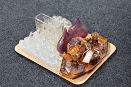 A tray of glass jelly mould, five piece smoked glass dressing table set,