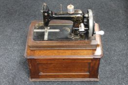 An early twentieth century mahogany cased hand sewing machine