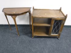 An oak three tier serving trolley with cupboard together with a walnut hall table
