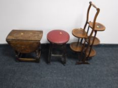 A small oak drop leaf coffee table together with folding oak five tier cake stand and leather