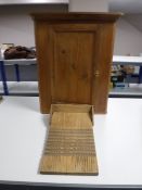 A pine hanging corner wall cupboard together with a pine washboard