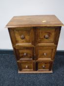 A contemporary hardwood miniature six drawer chest