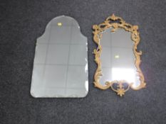 An early 20th century decorative frameless bevelled edge mirror together with an ornate gilt framed