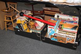 Two boxes of assorted toys and board games, vintage roller skates, girls world dolls head,