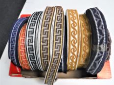 A box containing nine spools of vintage Silver Cross pram trim