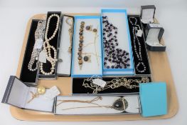 A good collection of costume jewellery to include a suite of Tiger's eye necklace earring and