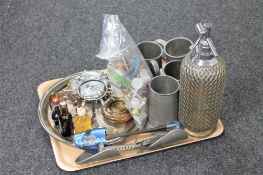 A tray of soda siphon, tankards, plated ware, shoe stretchers,