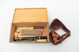 A Victorian Meerschaum carved pipe together with ivory cheroots etc