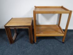 A nest of three teak G-plan tables together with a teak two tier serving trolley