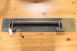 A 1920's brass door handle with large finger plate